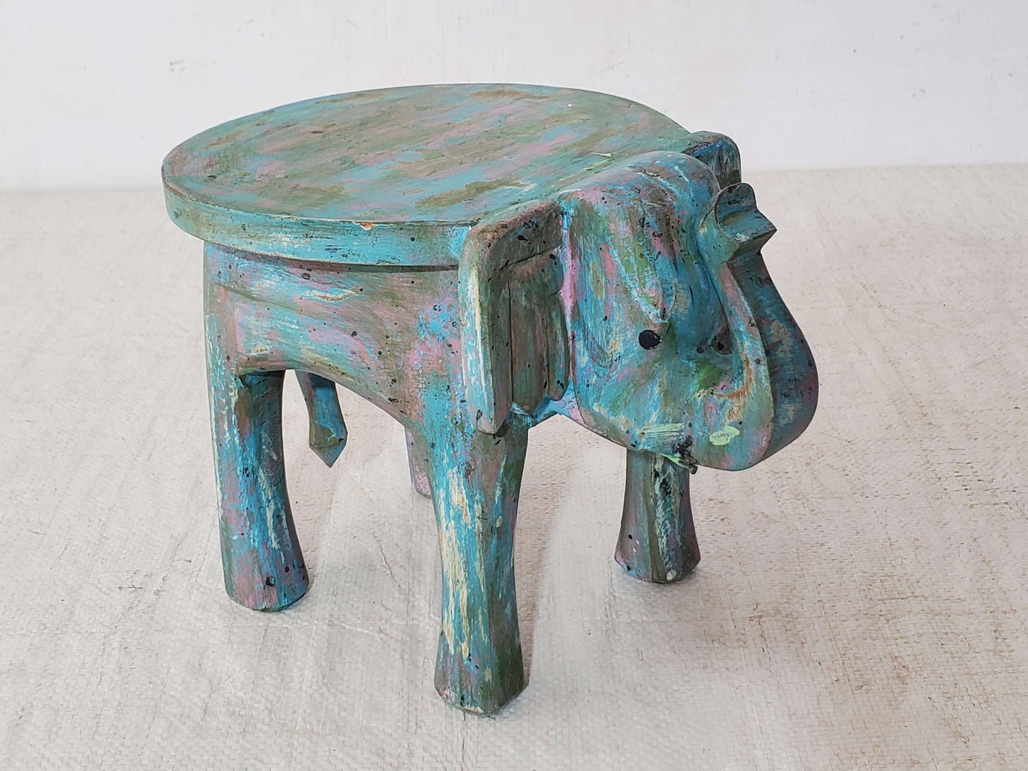 Wooden stool with animal design on a white background