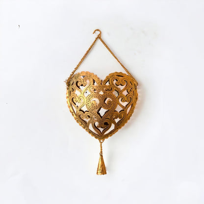 Decorative gold heart-shaped hanging ornament on a white background