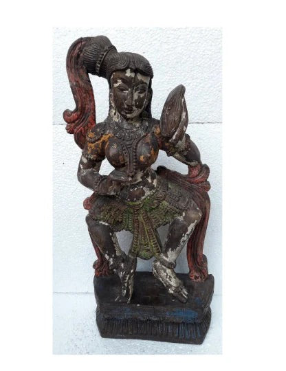 Decorative statue of a seated figure with intricate details on a white background
