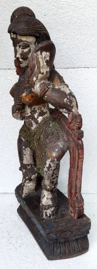 Wooden statue of a figure with a white background