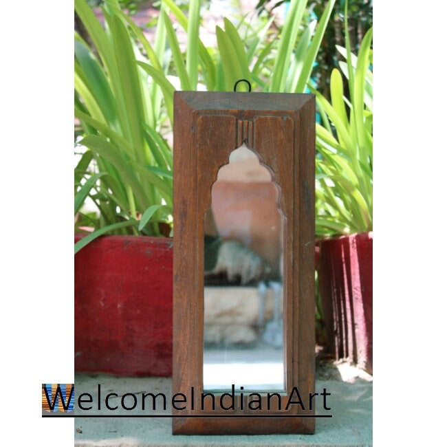 Wooden lantern with a pink interior against a natural background