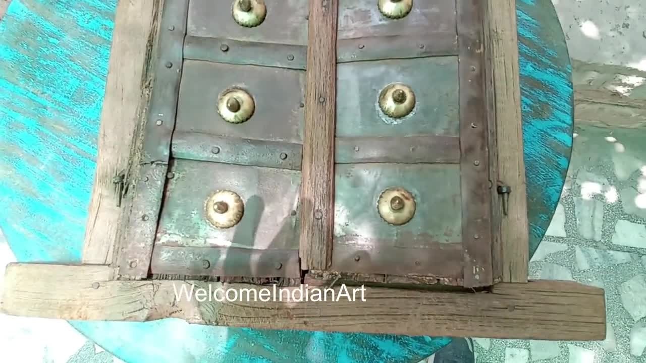 Wooden panel with metal accents and decorative elements on a blue background