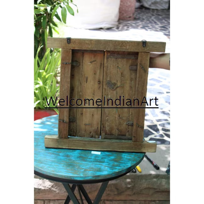 Wooden frame on a glass table with 'WelcomeIndianArt' branding