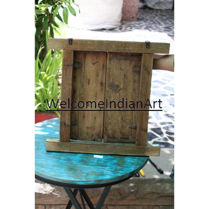 Wooden frame on a glass table with 'WelcomeIndianArt' branding