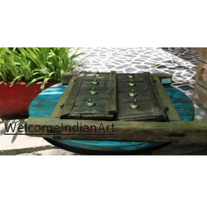 Wooden art piece on a blue surface with 'Welcome Indian Art' text