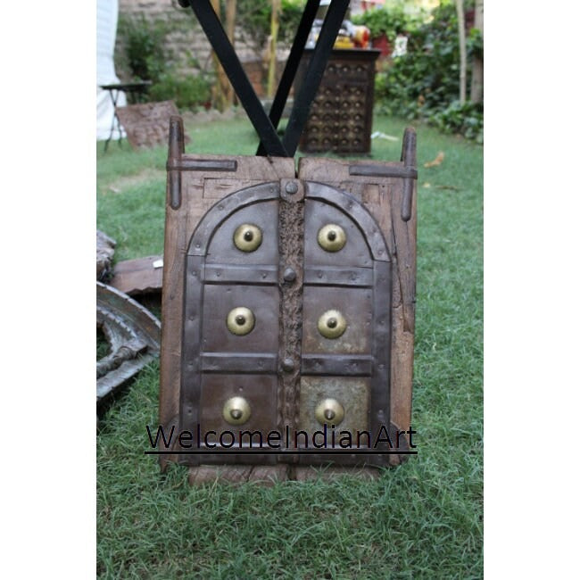 Decorative wooden door with brass knobs on a grassy background, featuring 'WelcomeIndianArt' branding.