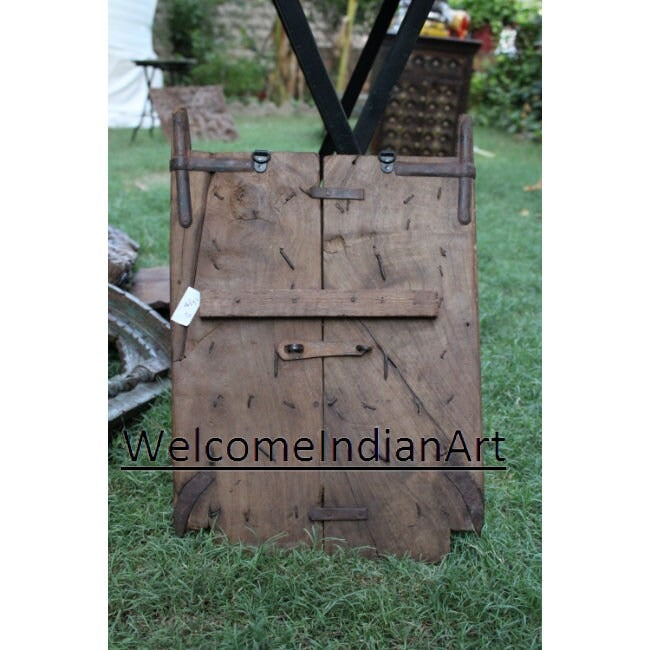 Wooden gate on grass with 'Welcome Indian Art' branding