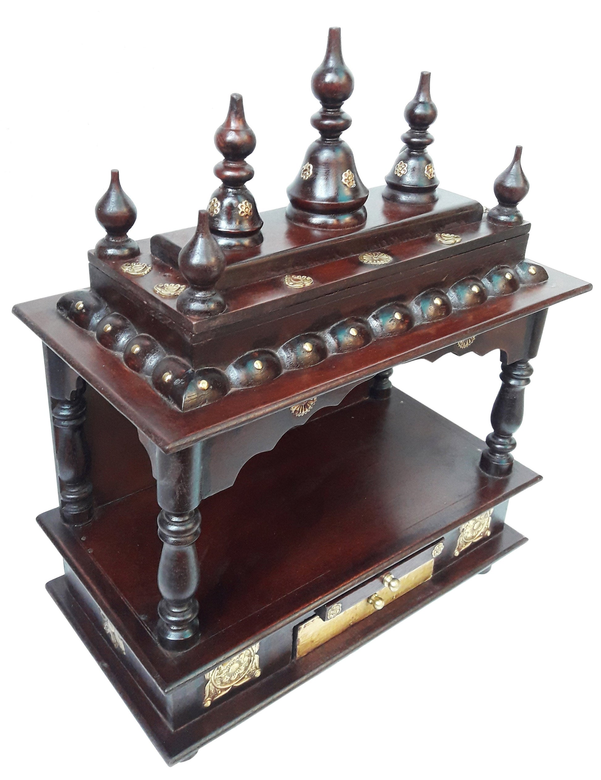 The Handcrafted Wooden Pooja Ghar Art Wooden by INDIAN CRAFTS STORE features ornate carved pillars, gold accents, dome finials, and two tiers—an elegant home temple ideal for displaying idols or gifting as a beautiful home décor piece.